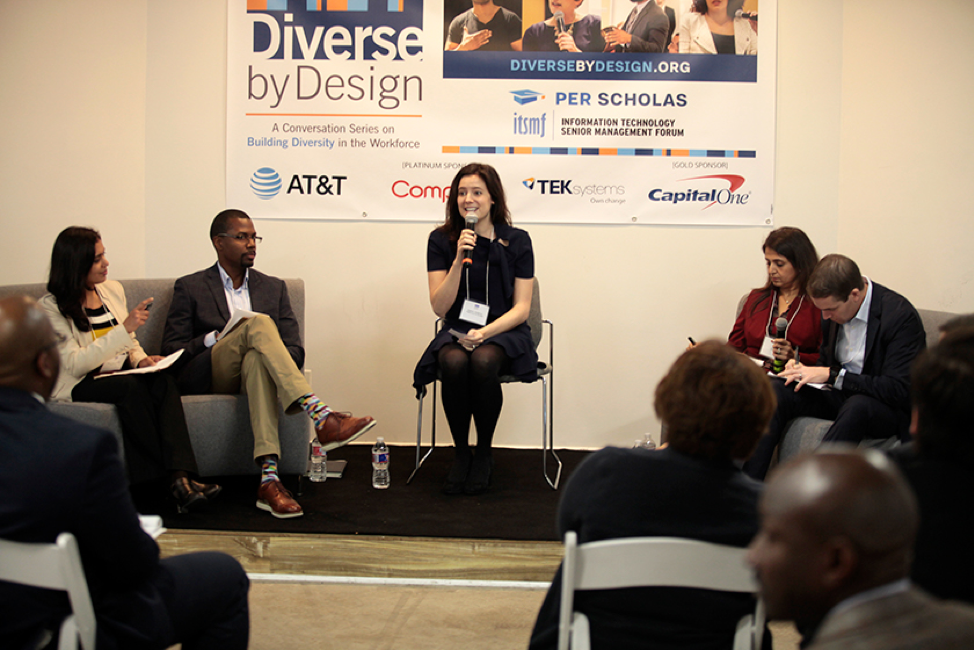 Panelists sit onstage at a Per Scholas "Diverse by Design" discussion; a woman center speaks into a microphone while others listen and take notes.