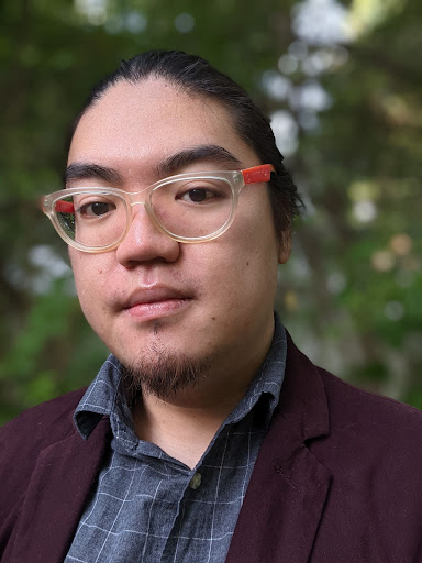 Per Scholas graduate headshot photo with trees in background