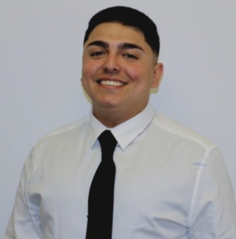 Smiling man in a white shirt and black tie.