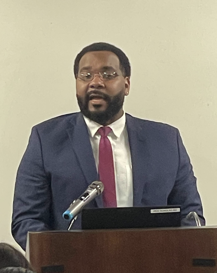 Man speaking at a podium.