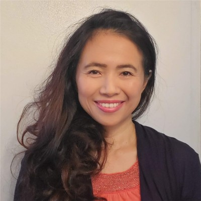 Smiling adult woman facing the camera in a head-and-shoulders portrait.