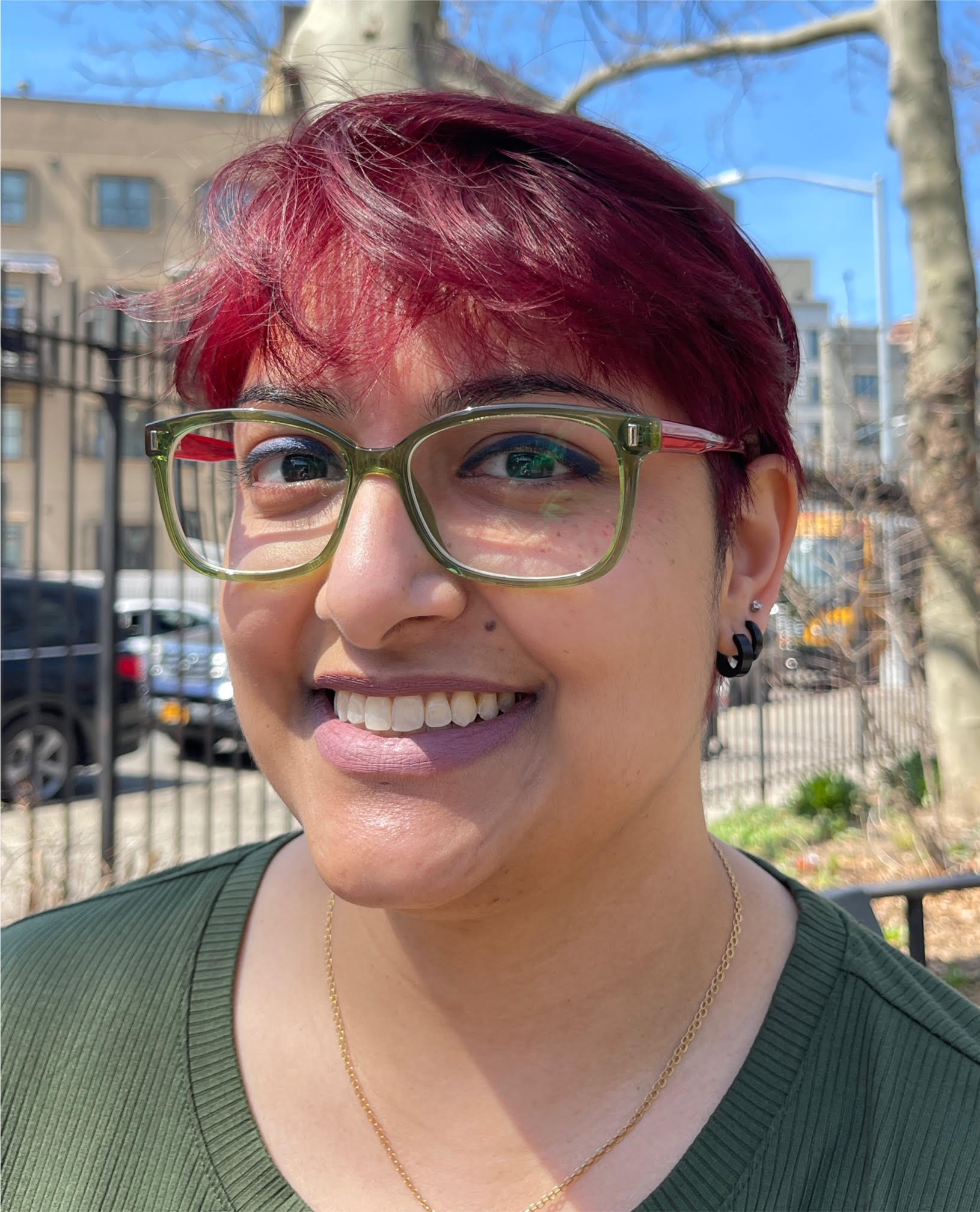 Smiling adult photographed outdoors.