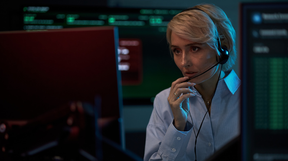 Cybersecurity analyst monitoring threat data on multiple screens in a security operations center