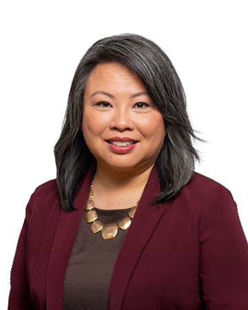 Headshot of Pam Kingpetcharat smiling against a plain background.