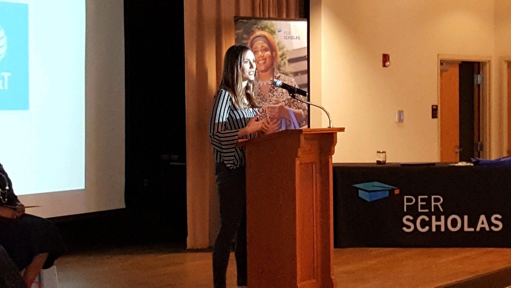Woman speaking at a podium during a Per Scholas event.