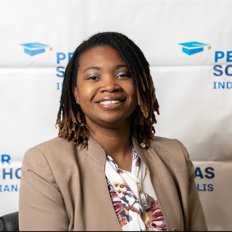 Smiling adult woman posing in front of a Per Scholas Indianapolis backdrop.