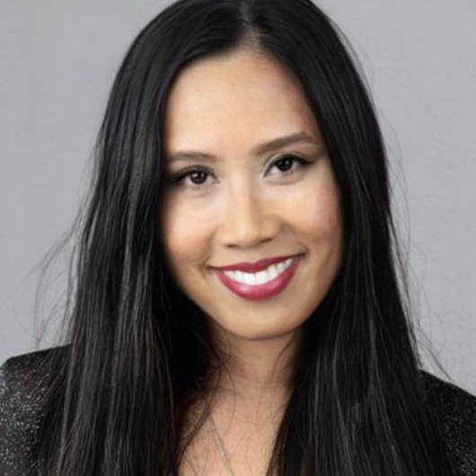 Headshot of Diah Anggraini with long straight hair against a plain gray background.