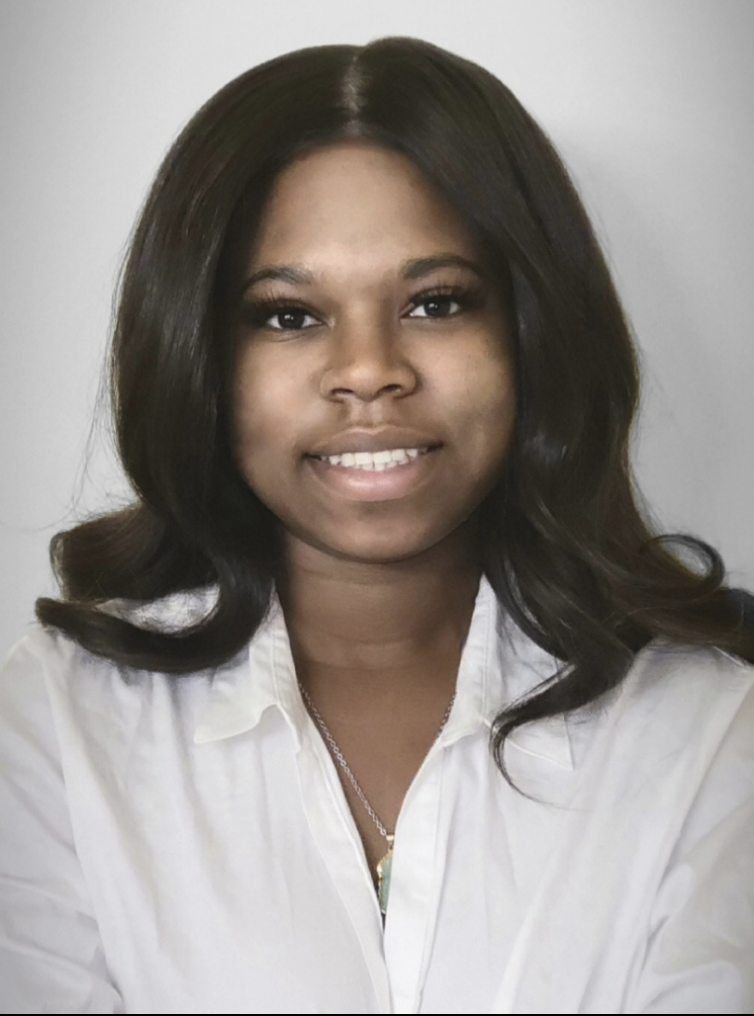 Head-and-shoulders portrait of a woman smiling at camera.