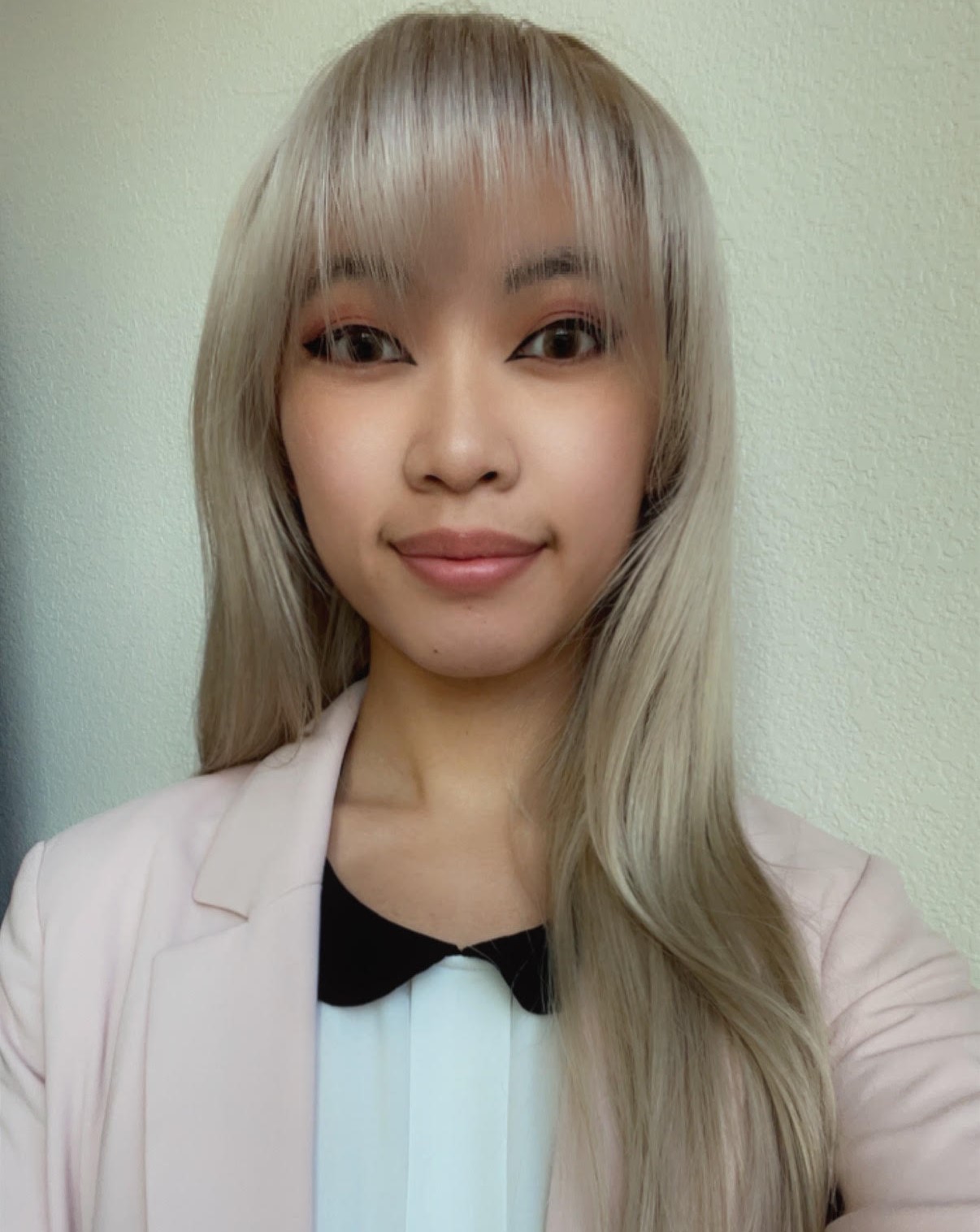 Autumn Truong, Per Scholas graduate, in a sweater and professional attire.