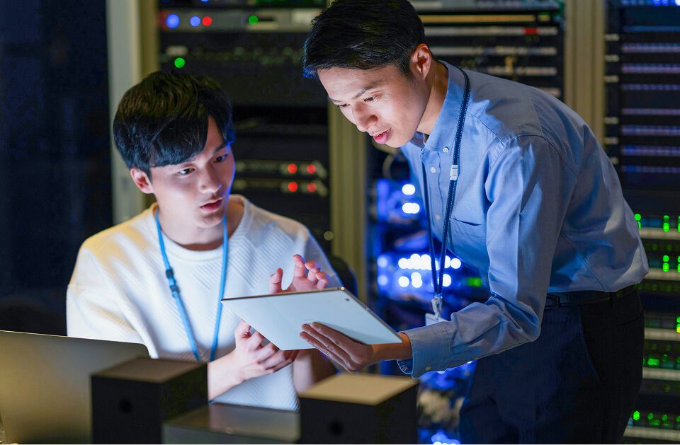 Group of engineers reviewing code in data center