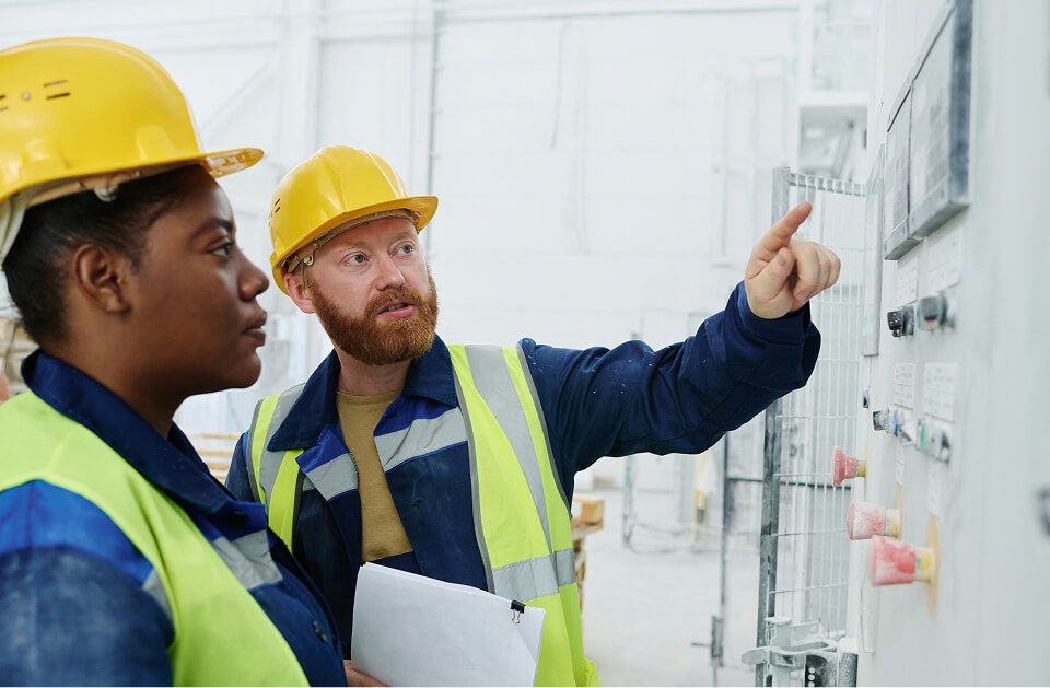 Group of technicians working on control panel