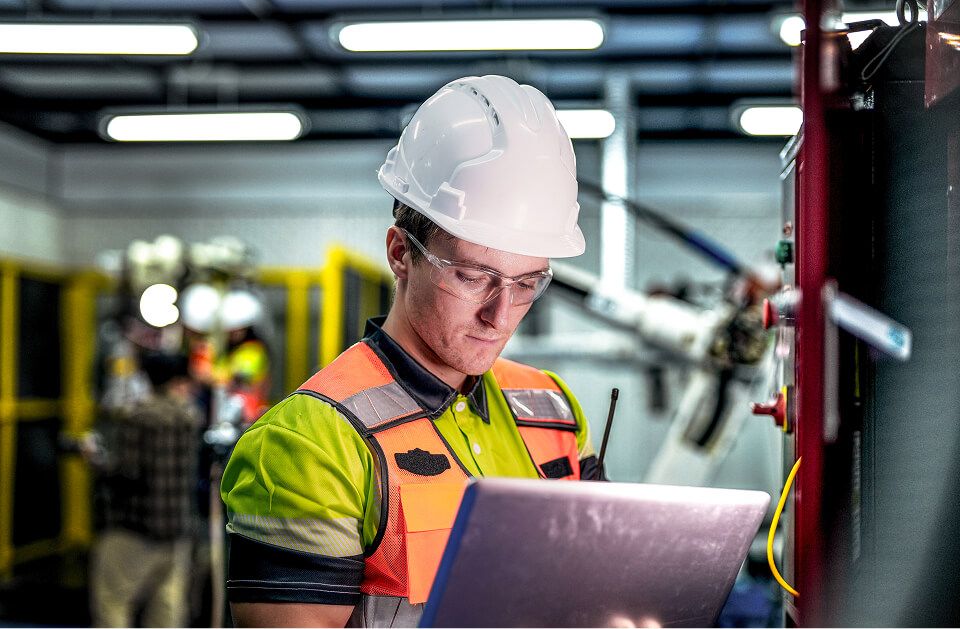 An engineer using a laptop in data center