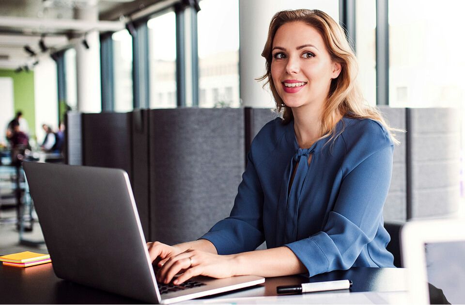 Worker with laptop sitting in office