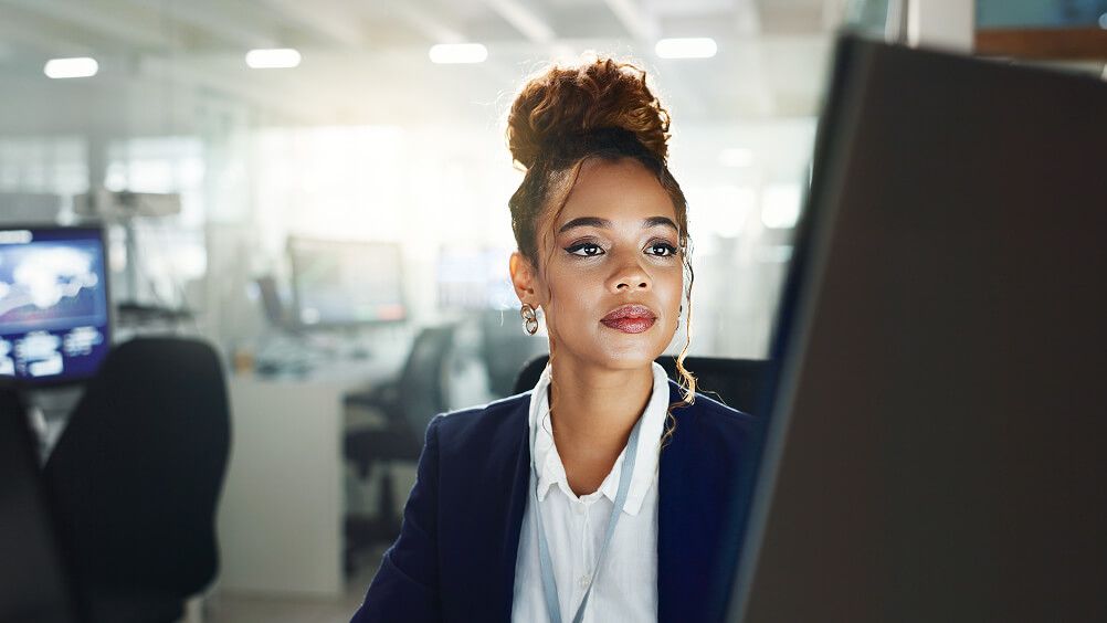 Employee sitting at desk looking at computer