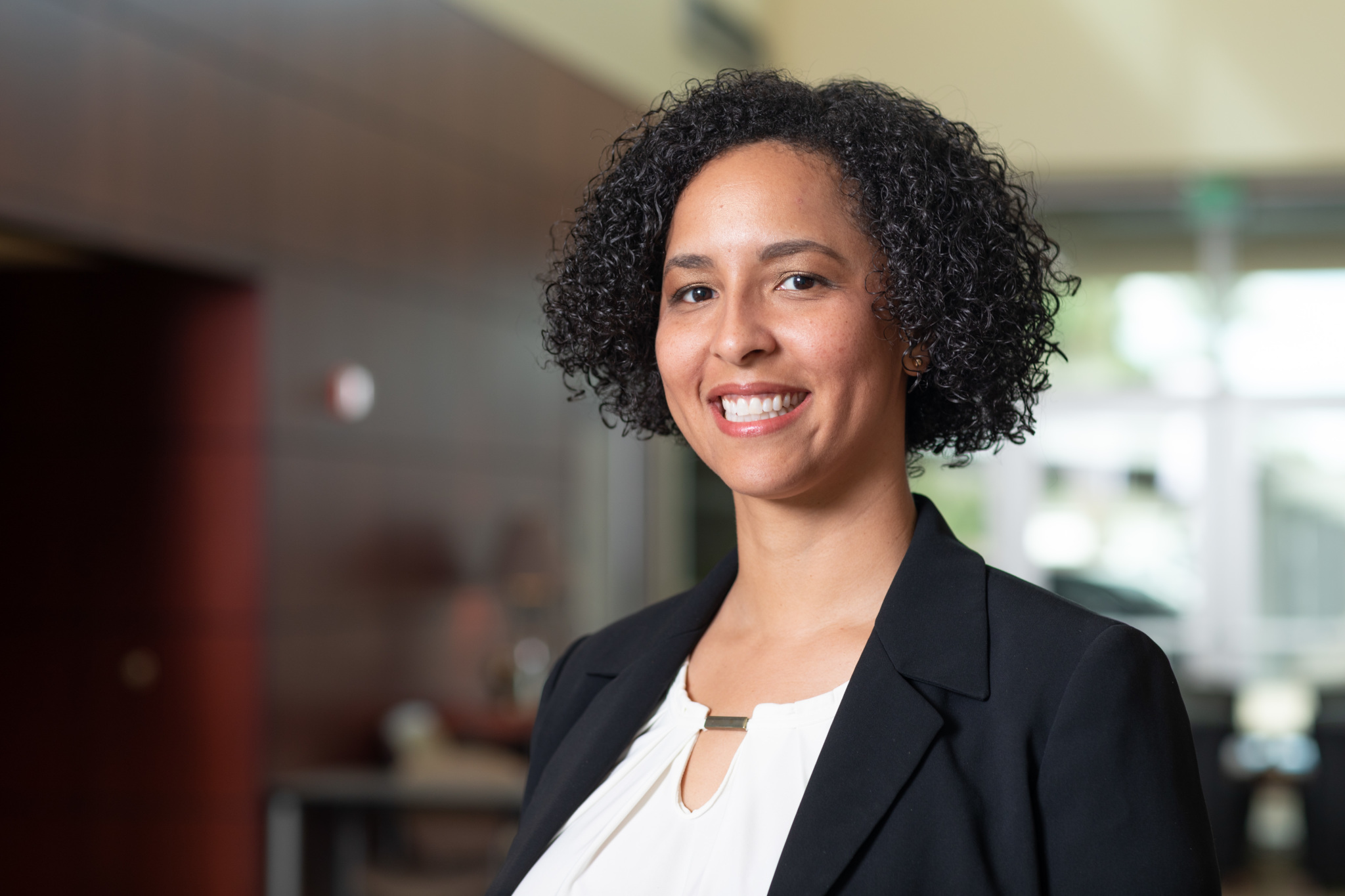 Headshot of Jaclyn B., smiling professional in an office setting.