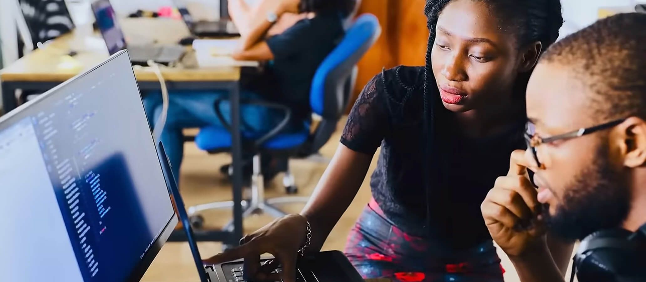 Students in classroom learning at computer