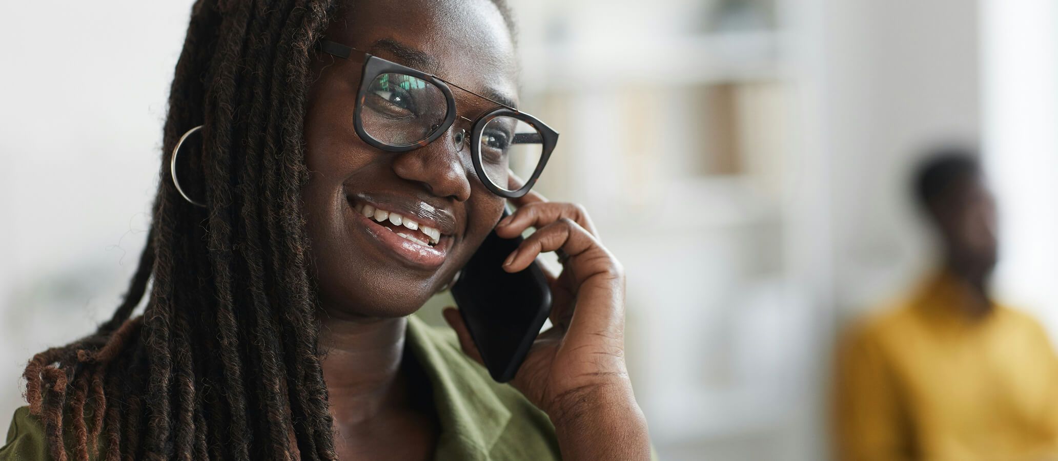 Woman holding and speaking into phone