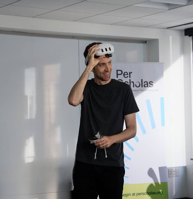 male student using VR headset in classroom