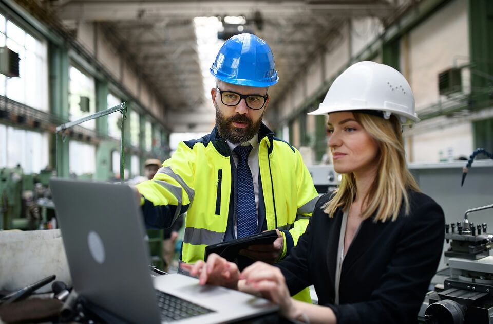 Two professional technicians working on laptop.