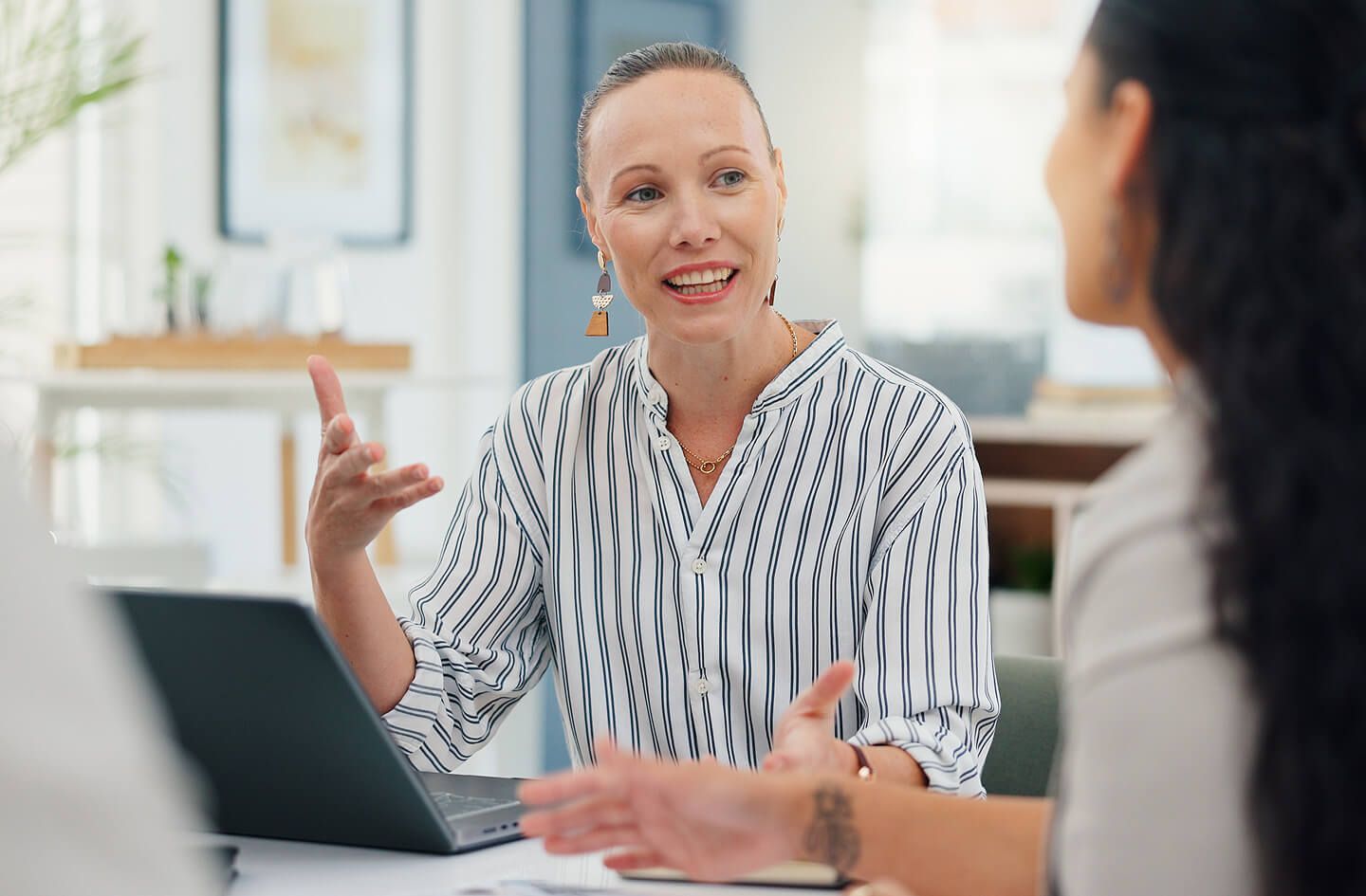 Woman seated at desk while mentoring employee