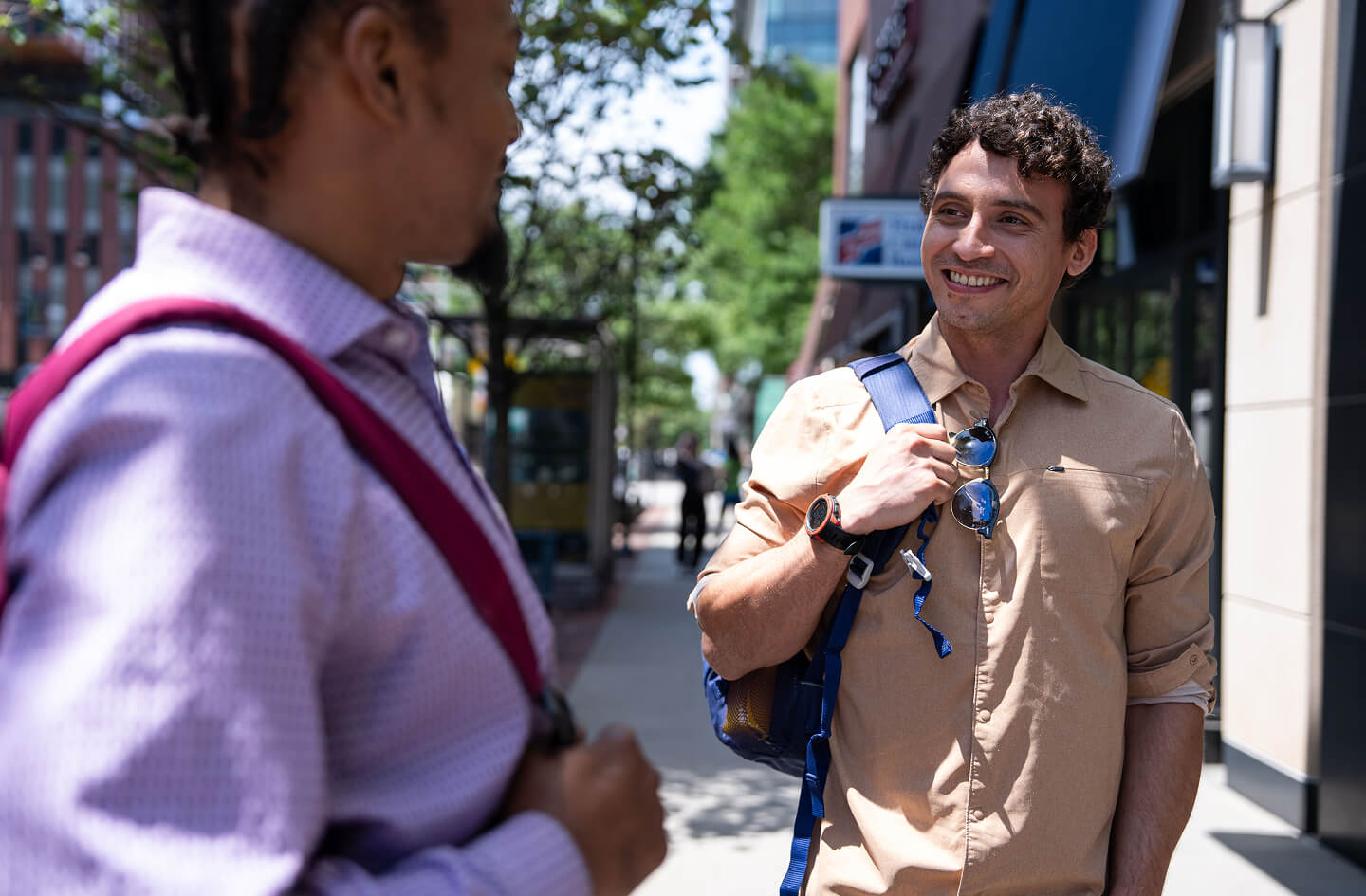 Alumni having conversation with student outside of campus