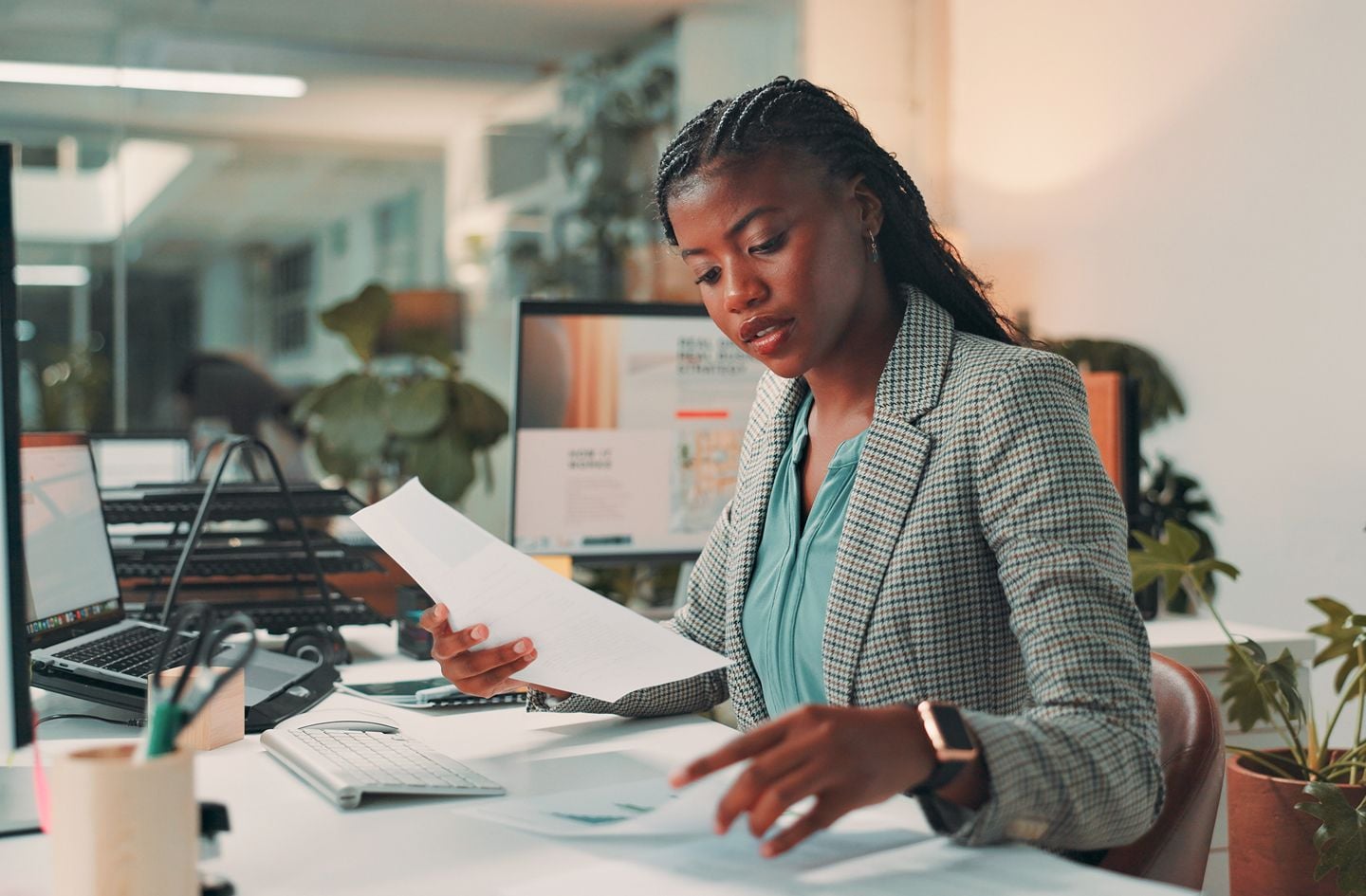 Employee seated at desk looking through documents